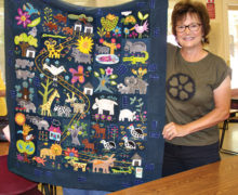 Nancy Kirk, Agave art group member, shows off her beautiful wool applique quilt.