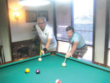 Lucky Shot Pool Club players Ed Allen (left) and Larry Stadler square off at the table.