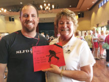 Sun Lakes Fire Department Captain Cory Evans and Cottonwood Lady Niner Sandy Jackson selling raffle tickets at the March 10 Member-Guest.
