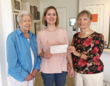 PCE grant recipient Raena Woods is presented a check by Lucy Everingham and Becky Paschal-Snyder of Chapter DD.