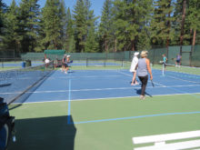 Pickleball players in Incline Village, Nevada playing on double striped tennis court.