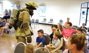 SLFD firefighter Dave DeGraaf shows children up close how different a firefighter looks and sounds inside of a fire.