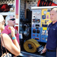 Though the event was held for school age children many adults came and asked questions. SLFD Engineer Dave DeGraaf explains how much water is held in his fire engine.