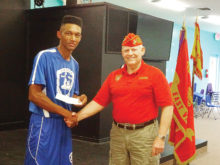 Young Marine SSgt. Tyson Henry receives a donation from East Valley Marines Sr. Vice Commandant Dave Lott.