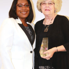 Pictured left to right are Sheena Oliver, Vice President of Marketing for Oticon, Inc. and Elizabeth Booth, Advocacy Category winner.