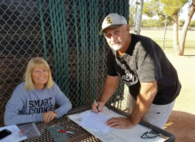 Cyndy Hilby “mans” our sign-up table as Gary Hillabolt fills out his application for the 2016-17 softball programs.
