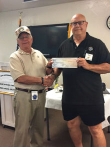 Jay accepts a check from Knights of Columbus’ Ken Stosel