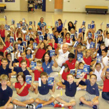 Rotarians Gary and Bonnie Whiting present dictionaries to third grade students at Navarette Elementary School.
