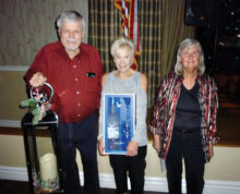The door prize winners from the December dance are from left to right: Rob Calhoun, Nancy Roger and Andrea Daily.