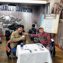 San Tan Crown Rotarians Terry Lubsen and James Kame hard at work selling Cow Pie Bingo tickets at Chandler Harley-Davidson January 7, 2017.