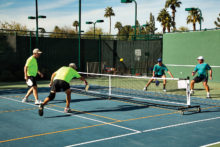 EVIL (East Valley Interclub League) pickleball players (yellow shirts) battle against their opponents