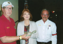 Casino Chair Lion Larry Palmer presents Jamie Trischler, winner of 50/50 drawing, with $560. Lion Bob Scully is on the right.