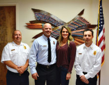 SLFD Chief Troy Maloney (left) and Deputy Chief Rob Helie (right) pose with newly-promoted Captain Nate Stringfellow with his wife Rochelle after his badge pinning.