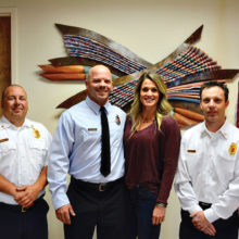 SLFD Chief Troy Maloney (left) and Deputy Chief Rob Helie (right) pose with newly-promoted Captain Nate Stringfellow with his wife Rochelle after his badge pinning.