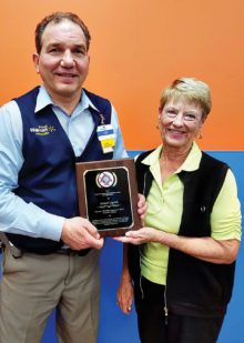 Joe Liguori, Manager, Walmart Superstore 2671 in Chandler, being presented with a plaque of appreciation by Betty Peer, Chairman, Veterans and Family Services, Sun Lakes VFW Post 8053 Auxiliary