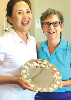 E.J. Toon receives her Club Championship prize from club President Betty Schechter