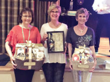March door prize winners are (left to right) Mary Yasuda, Jackie Morgan and Jan Wilkinson receiving the gift on behalf of Laurie Starr.