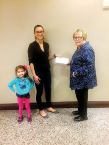 Geri Hall from P.E.O. Chapter DD, Sun Lakes, presents PCE grant recipient Melissa Leffler (with daughter “Izzy”) with the P.E.O International Grant Award for Continuing Education.
