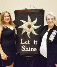 Suzanne Young (left) and Barbara Grimes (right) with state regent's banner