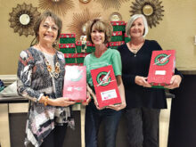 Sue Elsner, Connie Huisken of Operation Christmas Child, and Sue Reynhout with donated shoeboxes