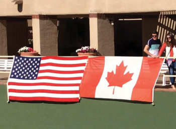 The flags of both countries hang on center court.