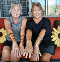 Sandy Peterson and Patti O’Neill show off a variety of bracelets created in the SLRGS Club shop using copper and mixed metals.