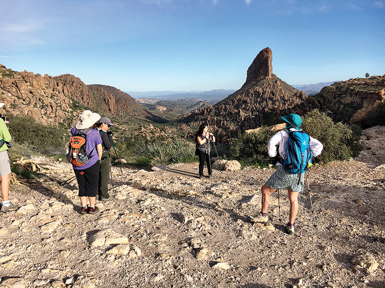 Sun Lakes Hiking Club members Tracy Nilsen and DeEtte Faith enjoy views of Weaver's Needle atop the Peralta Trail in the Superstitions Wilderness. (Photo by Warren Wasescha)