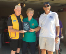 Sun Lakes Lions President Floyd Mullen with Lions of the Year Clark and Nancy Meiner