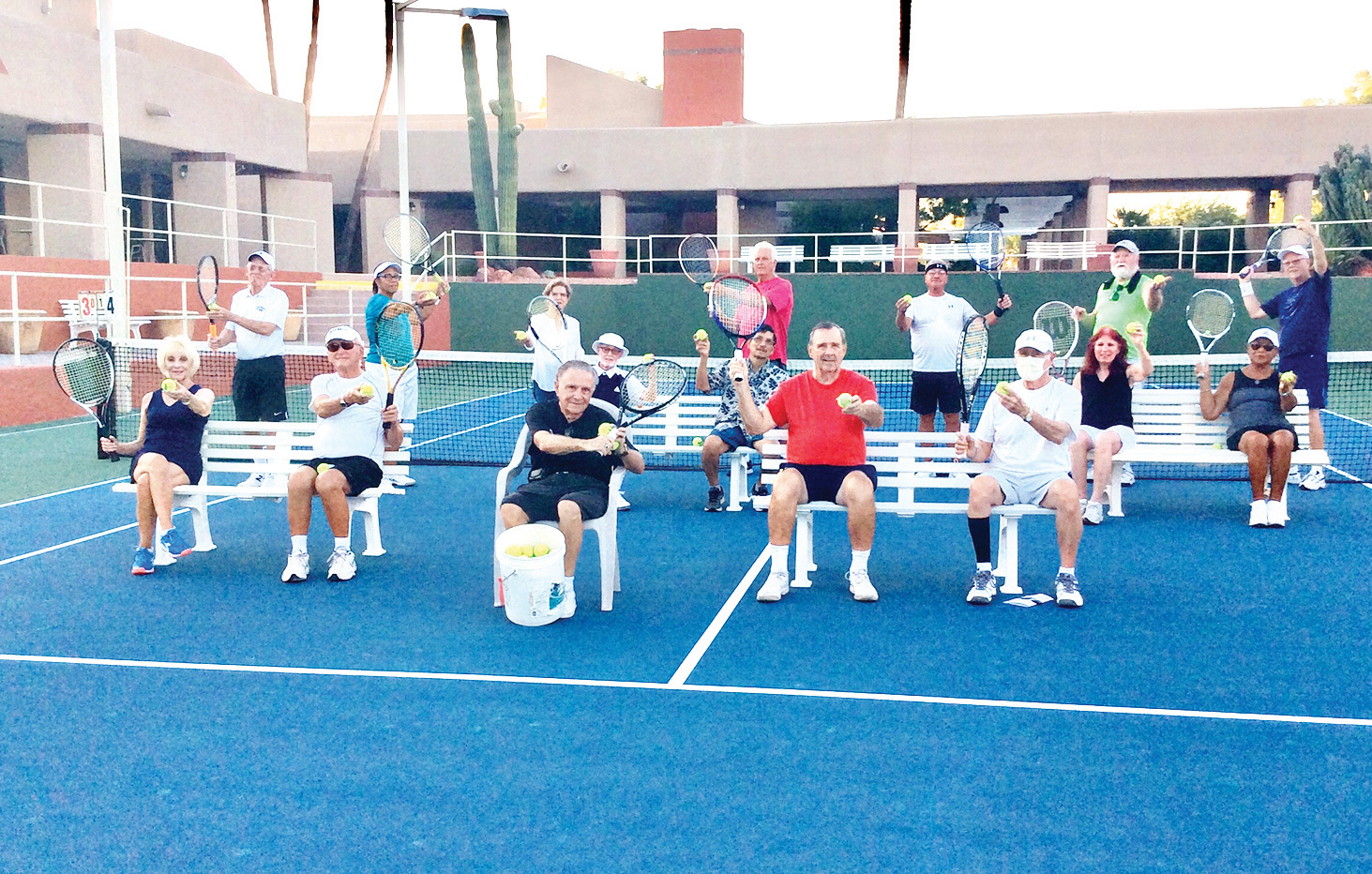 Teachers and students prepare for Cottonwood's free tennis clinics. Front row (seated): Karen Daugherty, Les Schick, Pierre Moresi (director with bucket of balls), Jerry Higgns, and Jim Southerland; second row (seated): Dick Kane, Joseph Fleming, Bonnie DeGrenier, and Sonda Giles; standing (left to right): Al Wagner (instructor), Ollie Johnson, Lucia Fleming, Cannon Hill, Jack Veit, John Arhangelsky, and Ken Griffin