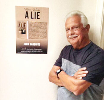 John Gaudioso with a poster of his book Three Weeks, a Lie