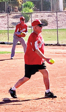 Bill Maxwell prepares to unload a pitch, while first baseman Wayne Newman (NOT Newton) intently looks on. (Photo by Perfect Pitch Studios)